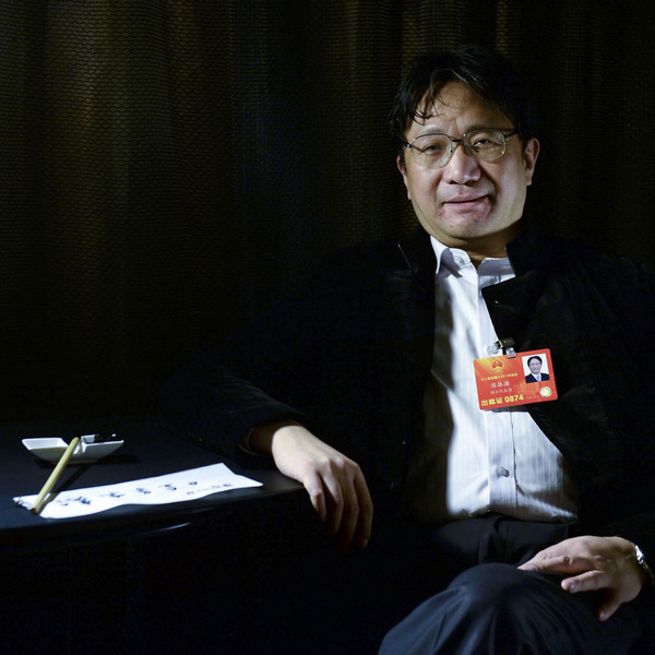 Chen Zhenglian, an NPC deputy and vice-chairman of the China Calligraphers' Association, poses with his some of his own calligraphy in Beijing, on March 4, 2013. Chen's dream is to establish a "Chinese characters writing day" and on this day, nationals – no matter how old or young they are – should experience Chinese character writing, especially calligraphy. The Internet age has threatened the use of Chinese characters as people are getting used to spelling in Pinyin, not writing, said Chen. He is appealing to the masses to protect Chinese characters and calligraphy. [Photo/Xinhua]