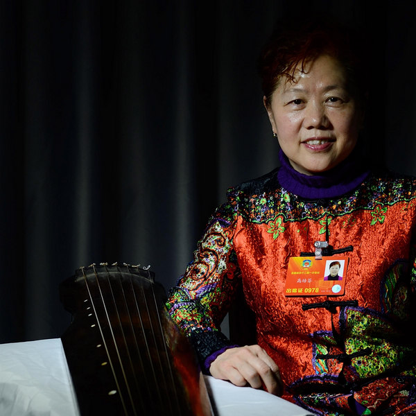 Gao Peifen, a CPPCC National Committee member and follower of the Zhucheng school of Guqin, poses with her Guqin in Beijing, on March 6, 2013. Gao Peifen's dream is to develop and publicize the Guqin, a traditional Chinese plucked seven-string musical instrument. [Photo/Xinhua]