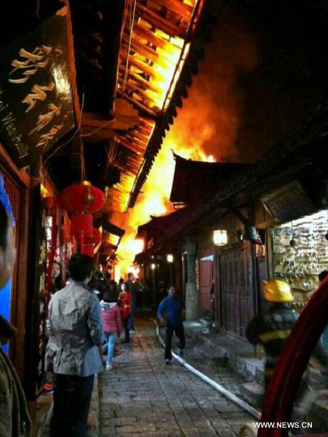 Photo taken on March 11, 2013 by cellphone shows a fire accident scene on Qiyi Street in the old town of Lijiang, southwest China's Yunnan Province. The fire broke out here at around 8:30 p.m. (1230 GMT) on Monday. No casualties were reported as of 10:00 p.m. Police and fire control units have been dispatched to the fire scene. (Xinhua)