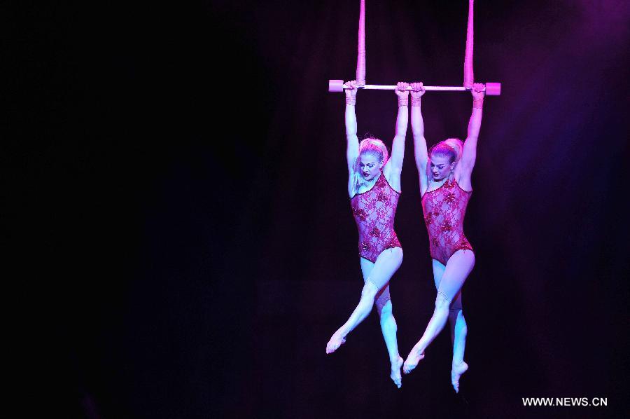 Acrobats perform during the media preview of the circus show "Le Noir" held in the Marina Bay Sands Theatre in Singapore, March 12, 2013. The show with the theme of "Black, white and red" premieres in Singapore Tuesday. (Xinhua/Then Chih Wey) 