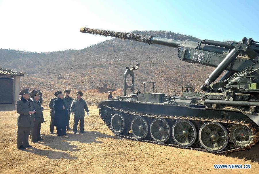Photo released by KCNA news agency on March 12, 2013 shows Kim Jong Un (3rd R), top leader of the Democratic People's Republic of Korea (DPRK), inspecting a long-range artillery sub-unit of Korean People's Army Unit 641, March 11, 2013. (Xinhua/KCNA)