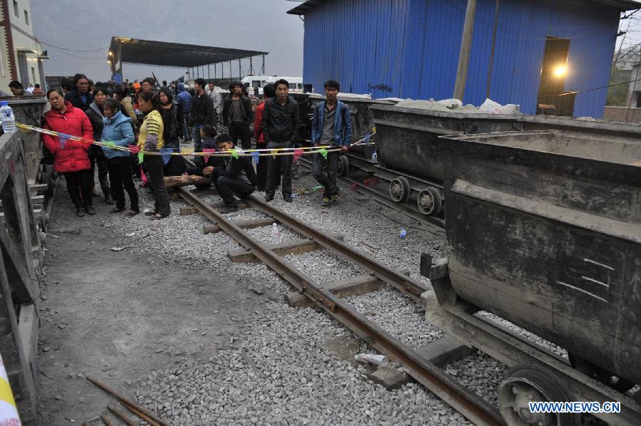 Relatives of the miners wait at the site of the accident in Shuicheng County, southwest China's Guizhou Province, March 13, 2013. Twenty-one miners were killed and four others were missing in a coal and gas outburst Tuesday evening at Machang Coal Mine which belongs to Gemudi Company of Guizhou Water & Mining Group. Eighty-three miners were working underground when the accident took place, and 58 of them managed to get to the ground safely. (Xinhua/Ou Dongqu)