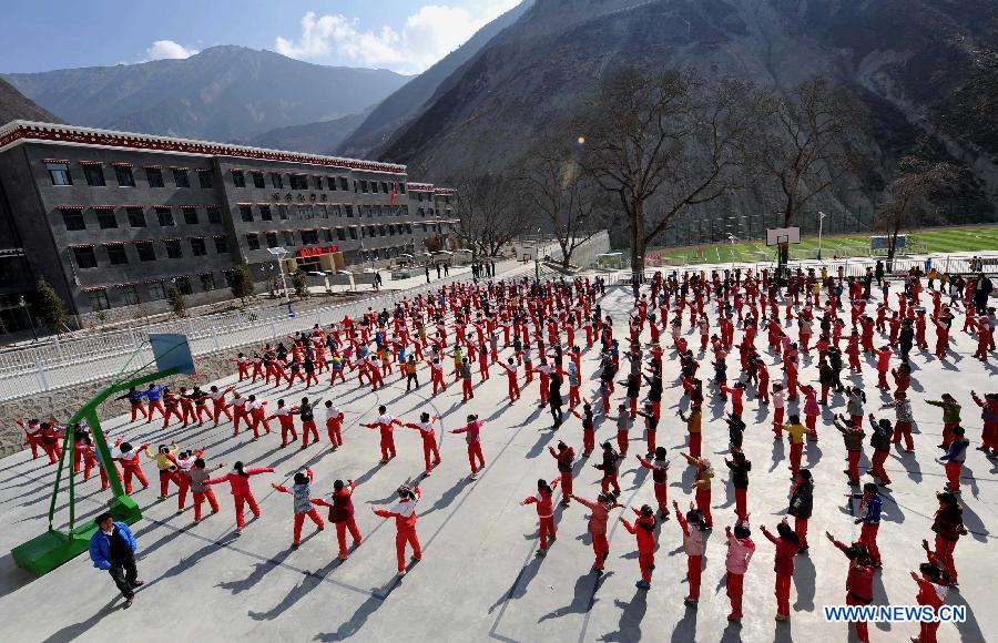Pupils do exercises at No. 1 Primary School of Deqin County in Diqing Tibetan Autonomous Prefecture, southwest China's Yunnan Province, March 12, 2013. A total of 1,260 pupils, most of whom are of the Tibetan ethnic group, study at this school, which was founded in September 2012. Pupils here are offered free meals and lodging. (Xinhua/Lin Yiguang) 