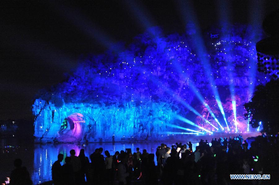 Tourists watch the hypermedia performance "Elephant-Legend" at the Xiangshan Park in Guilin City, southwest China's Guangxi Zhuang Autonomous Region, March 12, 2013. (Xinhua/Lu Bo'an) 