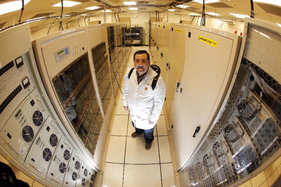 Image provided by the European Southern Observatory (ESO) on March 12, 2013, shows a correlator worker, Juan Carlos Gatica, posing in the middle of one of world's most powerful supercomputers. Atacama Large Millimetre/Submillimetre Array (ALMA) project is an international astronomical facility located 5,000 meters above Andes' El Llano de Chajnantor's plateau, some 50 km of San Pedro de Atacama in Chile's Second Region, in Antofagasta. The ALMA, an international partnership project between Europe, Japan and the United States, with the cooperation of Chile, is presently the largest astronomical project in the world and it will be inaugurated in Chile on March 13, 2013 to celebrate his transformation from a construction project to an observatory. (Xinhua/ESO)