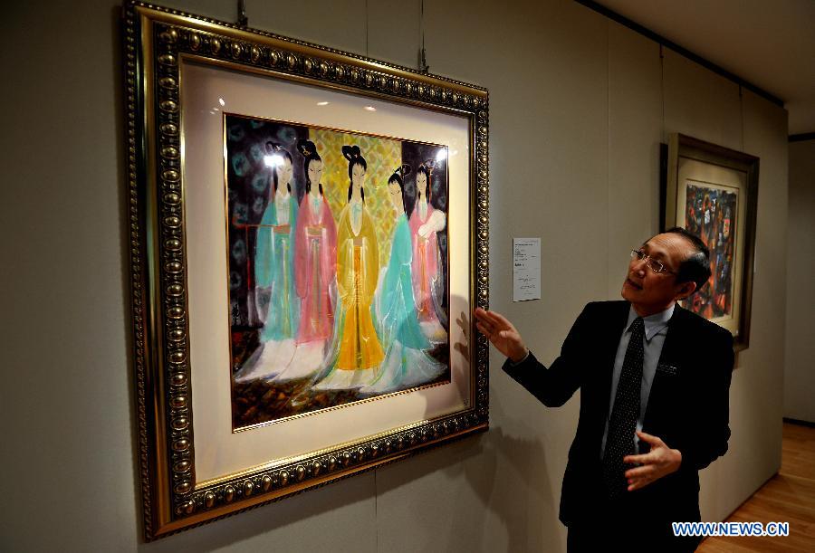 A working staff from the Sotheby's presents an artwork by Lin Fengmian valued at 8 million to 12 million Hong Kong dollars (about 1 million to 1.5 million U.S. dollars) in Hong Kong, south China, March 13, 2013. Sotheby's 2013 spring sales of fine Chinese paintings will be held on April 5 in Hong Kong. Over 300 pieces of artworks with a total value of more than 130 million Hong Kong dollars (about 16.6 million U.S. dollars) will be on display. (Xinhua/Chen Xiaowei)