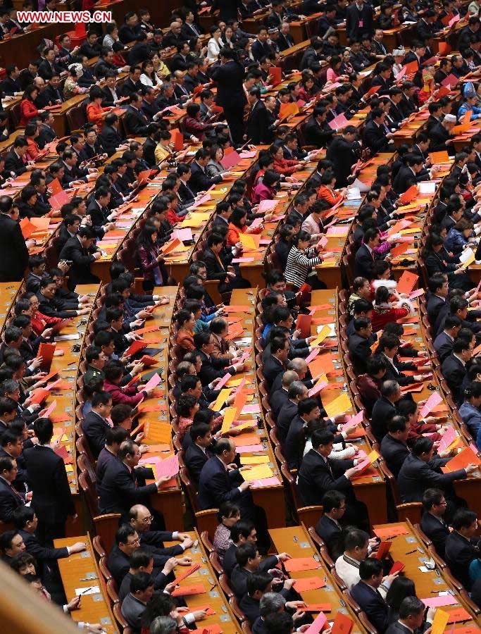 Deputies check their ballots at the fourth plenary meeting of the first session of the 12th National People's Congress (NPC) at the Great Hall of the People in Beijing, capital of China, March 14, 2013. Chairman, vice-chairpersons, secretary-general and members of the 12th NPC Standing Committee, president and vice-president of the state, and chairman of the Central Military Commission of the People's Republic of China will be elected here on Thursday. (Xinhua/Liu Weibing)