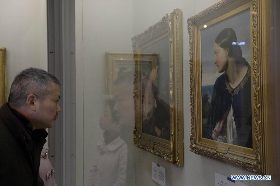 A visitor stares at a painting work at an exhibition showing British artworks in Nanchang, capital of east China's Jiangxi Province, March 14, 2013. An exhibition displaying 80 British art works kicked off here on Thursday. (Xinhua/Zhou Mi) 