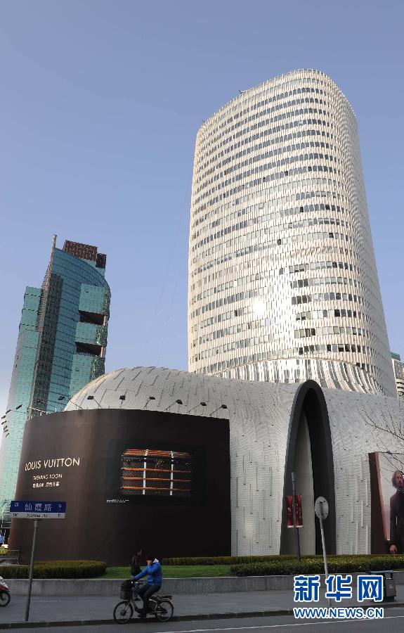 Photo taken on March 14, 2013 shows a boot-shaped building under construction in L' Avenue of Shanghai. The construction is nearly finished; the 134-meter building has floor area of 140,000 square meters, with 28 stories on ground and four stories underground. (Xinhua/Lai Xinlin )