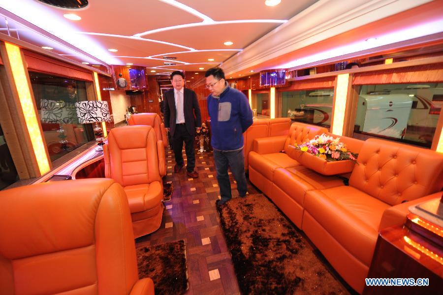 Visitors watch the interior of an expensive motor home during the 2013 China International Exhibition for Caravanning, Motoring, Tourism (CMT China) in Nanjing, capital of east China's Jiangsu Province, March 15, 2013. The three-day exhibition, with the participation of 289 exhibitors from 28 countries and regions, opened in Nanjing Friday. (Xinhua/Shen Peng) 