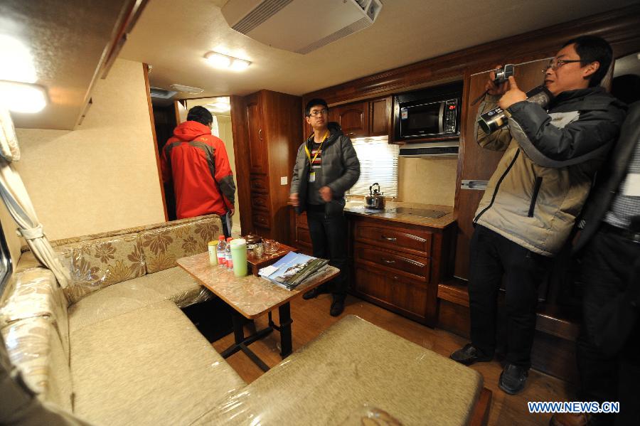 Visitors visit inside a motor home during the 2013 China International Exhibition for Caravanning, Motoring, Tourism (CMT China) in Nanjing, capital of east China's Jiangsu Province, March 15, 2013. The three-day exhibition, with the participation of 289 exhibitors from 28 countries and regions, opened in Nanjing Friday. (Xinhua/Shen Peng) 