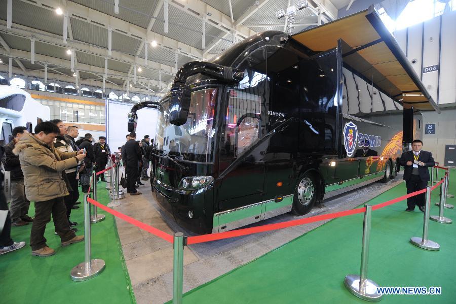 Visitors take photos of an expensive motor home during the 2013 China International Exhibition for Caravanning, Motoring, Tourism (CMT China) in Nanjing, capital of east China's Jiangsu Province, March 15, 2013. The three-day exhibition, with the participation of 289 exhibitors from 28 countries and regions, opened in Nanjing Friday. (Xinhua/Shen Peng) 