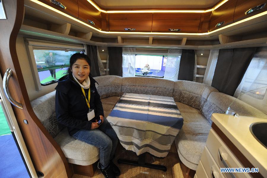 A staff member of an exhibitor presents the interior of a motor home during the 2013 China International Exhibition for Caravanning, Motoring, Tourism (CMT China) in Nanjing, capital of east China's Jiangsu Province, March 15, 2013. The three-day exhibition, with the participation of 289 exhibitors from 28 countries and regions, opened in Nanjing Friday. (Xinhua/Shen Peng) 