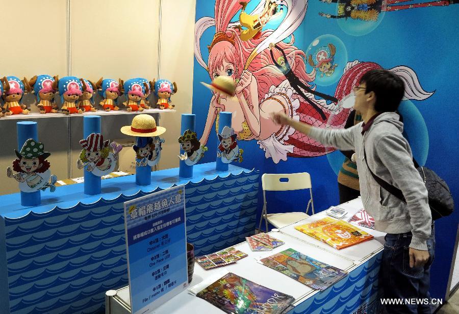 A visitor plays game at C3 in Hong Kong 2013, a Japanese anime (animation products) expo, in south China's Hong Kong, March 15, 2013. The three-day expo was inaugurated Friday at the Hong Kong Convention and Exhibition Centre. (Xinhua/Li Ying) 