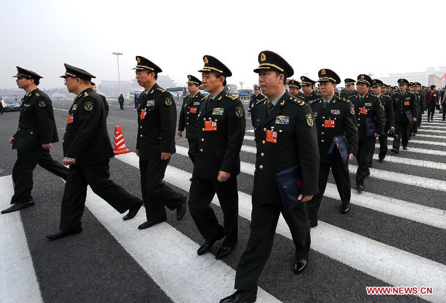 Deputies to the 12th National People's Congress (NPC) from People's Liberation Army walk to the Great Hall of the People in Beijing, capital of China, March 17, 2013. The closing meeting of the first session of the 12th NPC will be held in Beijing on Sunday. (Xinhua/Yang Zongyou)