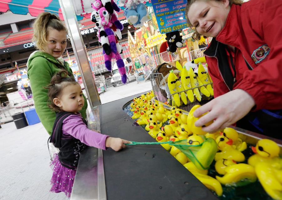 A girl enjoys a game at the Playdome carnival held at BC Place stadium in Vancouver, Canada. March 16, 2013. (Xinhua/Liang Sen) 