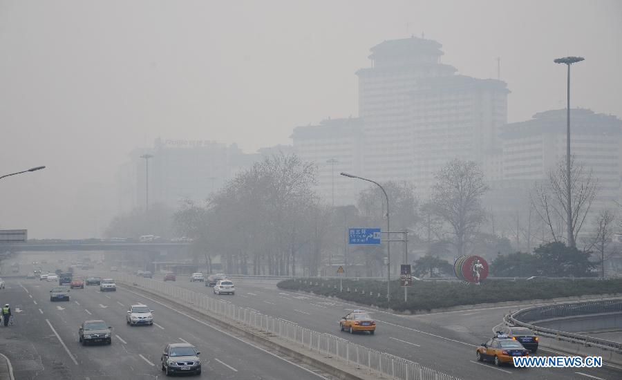 The fog-shrouded buildings are seen in Beijing, capital of China, March 17, 2013. Fog and smog blanketed Beijing on Sunday. (Xinhua/Li Xin)  