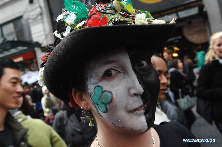 A woman takes part in a celebration for Celtic Festival, part of St. Patrick's Day celebrations, in Vancouver, Canada, March 16, 2013. More than 200,000 spectators are expected to fill the streets of Vancouver's downtown on Sunday for the annual St. Patrick's Day parade. (Xinhua/Sergei Bachlakov)