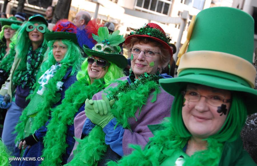 Colorfully dressed women participate in the annual St. Patrick's Day Parade in Vancouver, Canada, March 17, 2013. Thousands of people have crowded downtown Vancouver to watch as bagpipers, Irish dancers and hurlers paraded with dreadlocked dancers, green samba queens, and even a roller derby team took part in the 9th annual St. Patrick's Day parade. The festivities continue the centuries-old custom of partying on the saint's feast day, March 17, to honour his role of helping convert the Irish to the Catholic faith. (Xinhua/Sergei Bachlakov) 