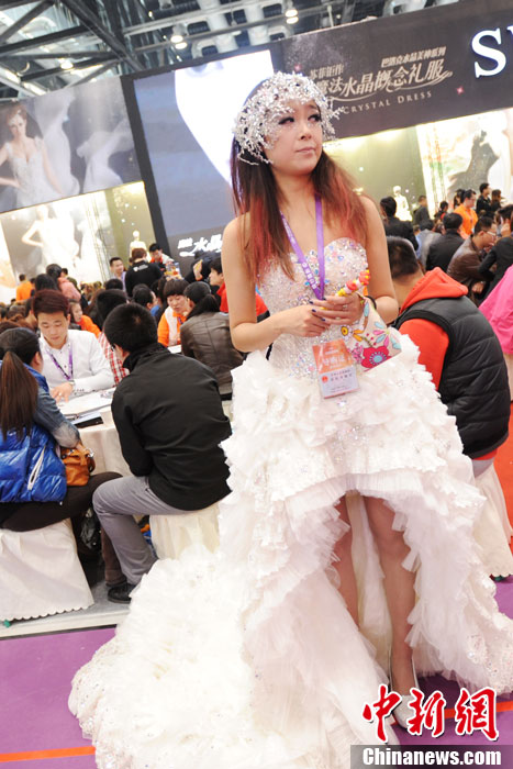 Models demonstrate wedding dresses all girls are dreaming for at the 2013 Beijing Wedding Expo for spring held in National Conference Center, March 16, 2013. The expo lasted for two days. (Photo/CNS)