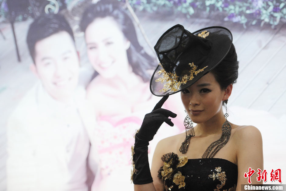 Models demonstrate wedding dresses all girls are dreaming for at the 2013 Beijing Wedding Expo for spring held in National Conference Center, March 16, 2013. The expo lasted for two days. (Photo/CNS)