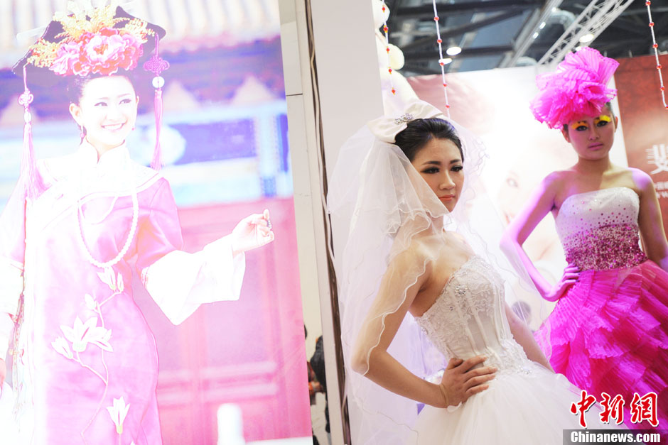 Models demonstrate wedding dresses all girls are dreaming for at the 2013 Beijing Wedding Expo for spring held in National Conference Center, March 16, 2013. The expo lasted for two days. (Photo/CNS)