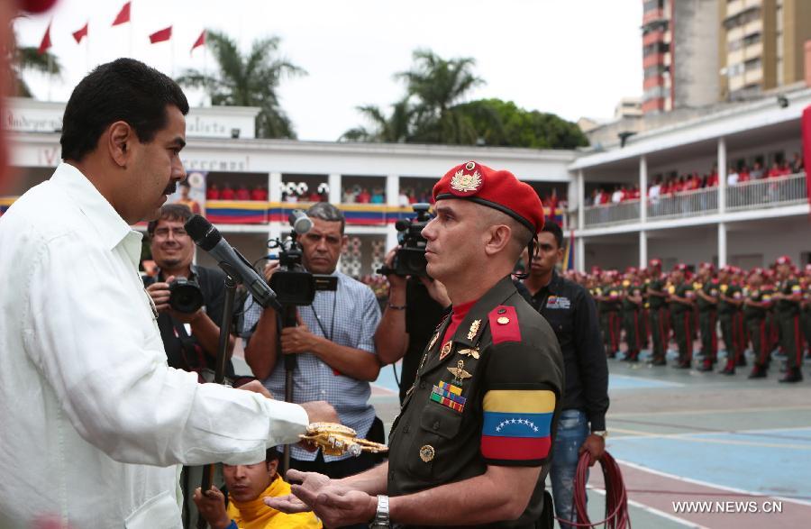 Image provided by Presidency of Venezuela shows Nicolas Maduro (L), commander in chief of the Bolivarian National Armed Forces, also Venezuela's Acting President, delivering a replica of Bolivar's sword to the Honor Guard during a ceremony commemorating the 14 years of government of the late Venezuelan President Hugo Chavez, in Caracas, capital of Venezuela, on March 17, 2013. (Xinhua/Presidency of Venezuela)
