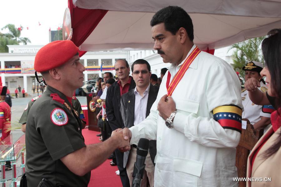 Image provided by Presidency of Venezuela, shows Nicolas Maduro (R), commander in chief of the Bolivarian National Armed Forces, also Venezuela's Acting President, attending a ceremony commemorating the 14 years of government of late Venezuelan President Hugo Chavez, in Caracas, capital of Venezuela, on March 17, 2013. (Xinhua/Presidency of Venezuela) 