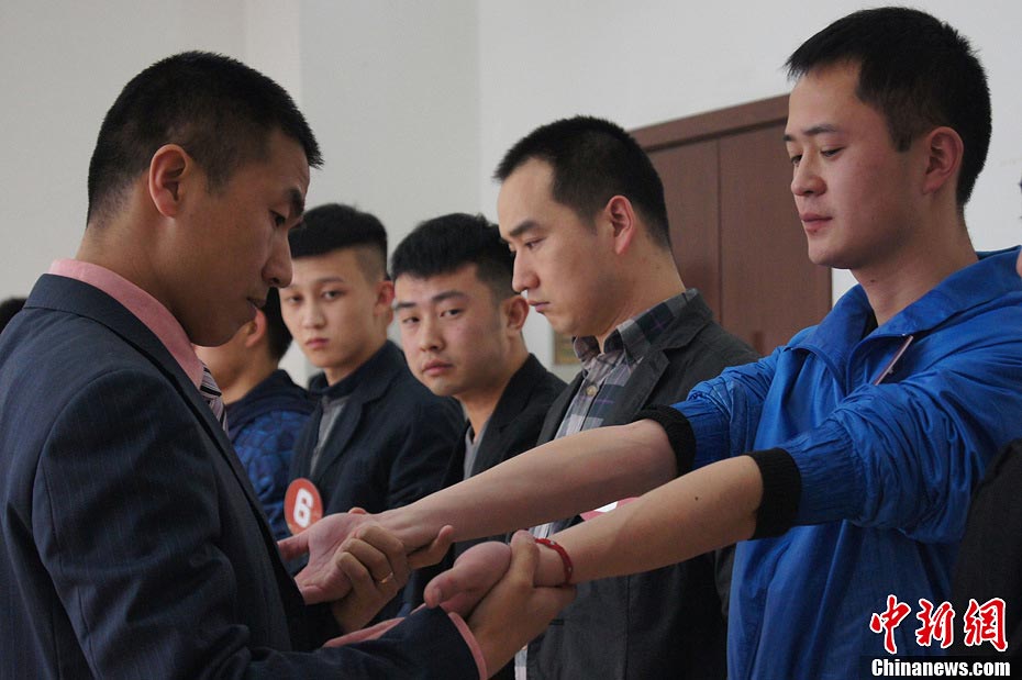 Candidate are in a test held to recruit flight security officers for Hainan Airlines, China's fourth largest airline, Taiyuan, northern China's Shanxi province on March 16, 2013. The airlines favored applicants who are graduates from military or police school or veterans. Besides appearance, applicants' manners, psychological quality in the interview, fighting skills and physical strength are also examined, which are essentials for flight security officers to deal with any emergent matter and security threat immediately. (Photo/CNS)  