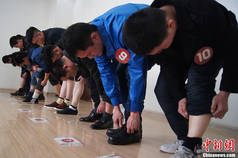 Candidate are in a test held to recruit flight security officers for Hainan Airlines, China's fourth largest airline, Taiyuan, northern China's Shanxi province on March 16, 2013. The airlines favored applicants who are graduates from military or police school or veterans. Besides appearance, applicants' manners, psychological quality in the interview, fighting skills and physical strength are also examined, which are essentials for flight security officers to deal with any emergent matter and security threat immediately. (Photo/CNS)  