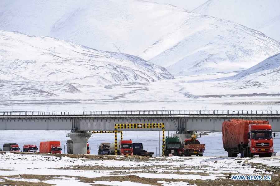 Trucks queue to pass the segment of state highway 109 which is covered with snow near Nalong Village in Damxung County, southwest China's Tibet Autonomous Region, March 18, 2013. A snowstorm here made an icy road on the segement of state highway 109 near Nalong Village, causing many vehicles truck on the road. (Xinhua/Liu Kun)