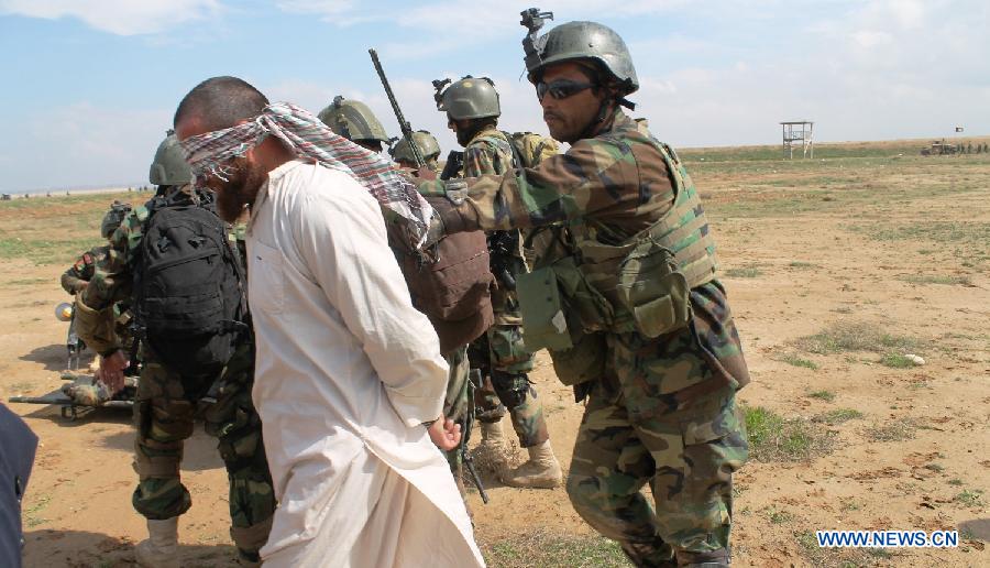 Afghan Army Commandos arrest a mockery insurgent during a military rehearsal in Mazar-e-Sharif, Balkh province, north Afghanistan, March 16, 2013. Several hundreds of Afghan National Army (ANA) commandos participated in a one-day military exercise here on Saturday. (Xinhua/Azorda)