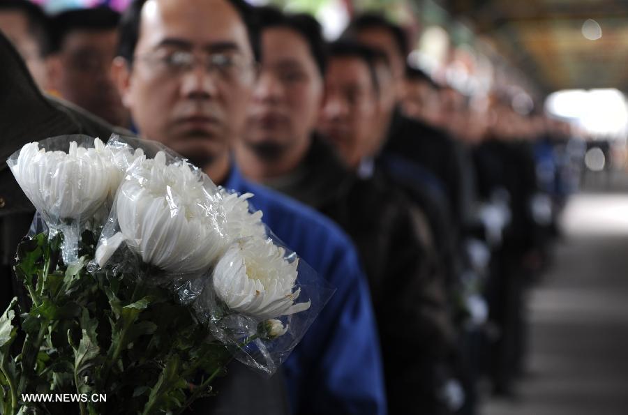 Employees of village-run enterprises queue up to express condolence to the death of Wu Renbao, the retired Communist Party of China (CPC) chief of Huaxi Village, outside the mourning hall in Huaxi Village of Jiangyin City, east China's Jiangsu Province, March 19, 2013. Wu, 85, died of cancer on Monday at his home in the village, which is one of the richest villages in the country. Renowned as China's most eminent farmer, Wu worked hard over the past decades to lead his villagers in striving for common wealth, an ideal regarded as one of the core principles of socialism. (Xinhua/Zhang Liwei)  