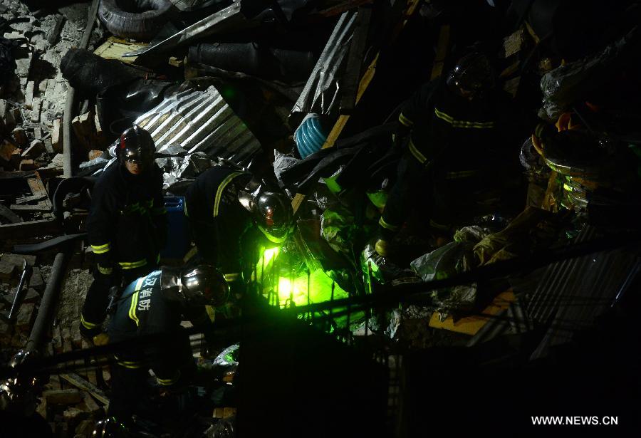 Fire fighters work at the blast locale of a residential building in Wuhan, capital of central China's Hubei Province, March 19, 2013. An explosion ripped through a residential building in Wuhan Tuesday night. Casualties from the blast that broke out at around 10 p.m. in Hanlai Square in the city's Hankou District are still unknown. (Xinhua/Cheng Min)