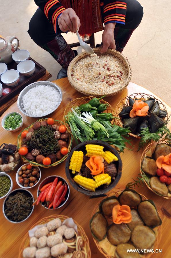 A competitor cooks youcha, a traditional local appetizer, in Guanyang County of Guilin, south China's Guangxi Zhuang Autonomous Region, March 19, 2013. A youcha cooking competition was held here on Tuesday to show the diet culture. (Xinhua/Lu Boan)