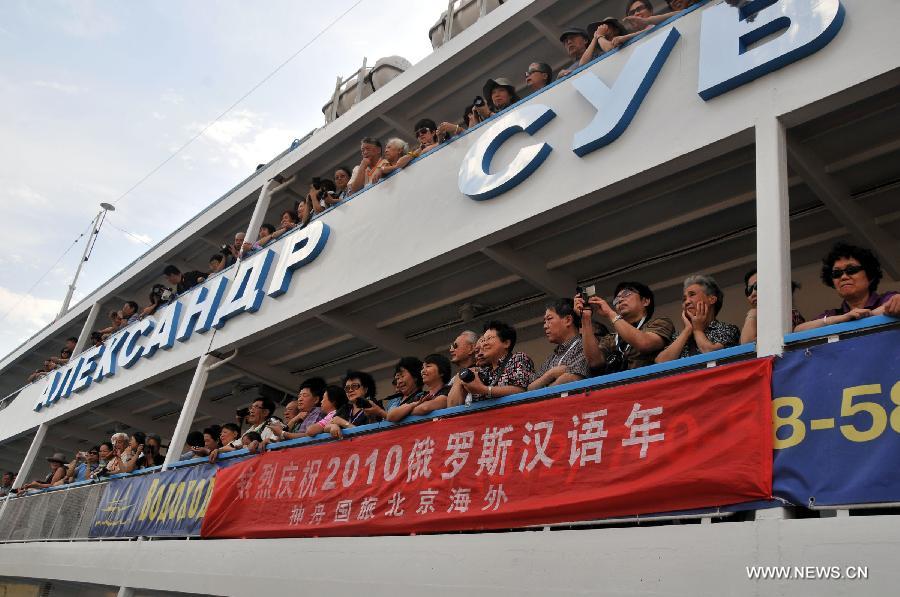 Some 300 Chinese tourists aboard the cruiser "Suvorov" start their trip to St. Petersburg under the framework of the Year of Chinese Language in Russia, at a dock in Moscow, Russia, July 29, 2010. The China-Russia cooperation in tourism has substantially progressed, which also has promoted bilateral understandings and exchange of culture in recent years. The Year of Chinese Tourism in Russia in 2013 will be inaugurated by Chinese President Xi Jinping when he visits Moscow later this month. (Xinhua/Gao Fan)
