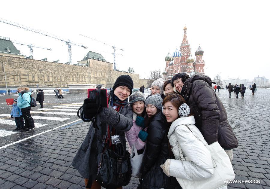 College students from south China's Hong Kong pose for a photo at the Red Square in Moscow, capital of Russia, on March 2, 2013. The China-Russia cooperation in tourism has substantially progressed, which also has promoted bilateral understandings and exchange of culture in recent years. The Year of Chinese Tourism in Russia in 2013 will be inaugurated by Chinese President Xi Jinping when he visits Moscow later this month. (Xinhua/Jiang Kehong)