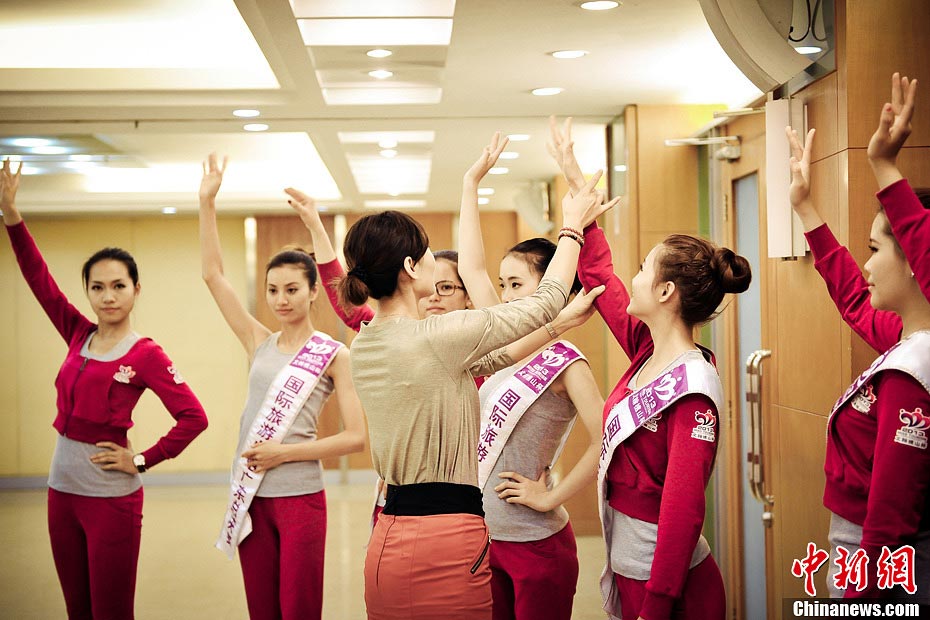 Trainer advises contestants how to build up good physique and deportment in Guangdong, March 19, 2013. More than 30 contestants who participate in the final round of the 2013 Miss Tourism International gather in Xijiao, China’s Guangdong province to attend a week-long training camp for better performance in competition. (CNS/ Long Yuyang)