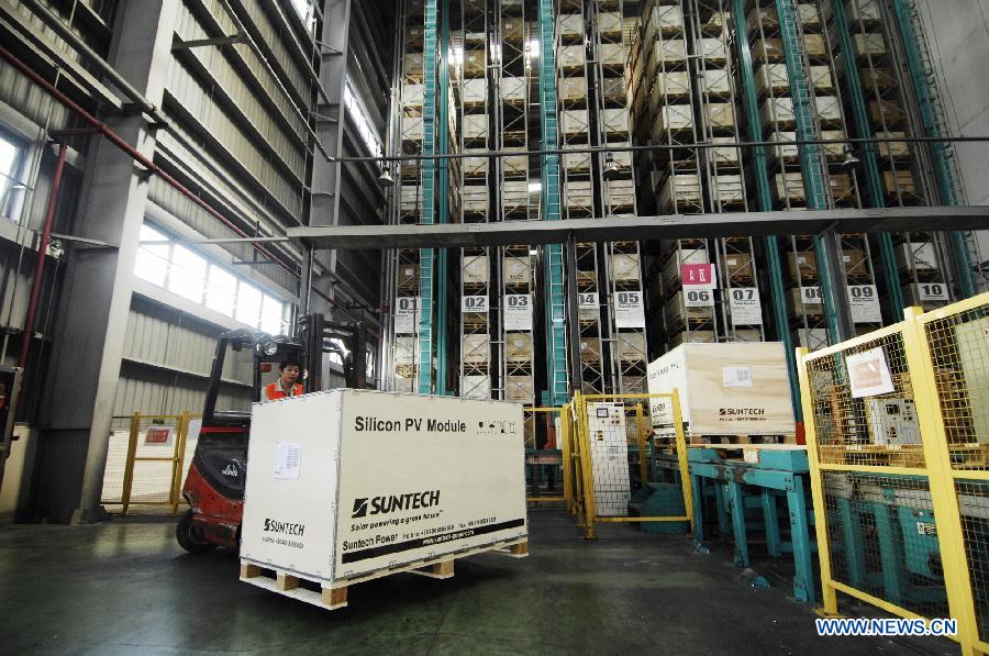 In this file photo taken on Sept. 26, 2011, a worker forklifts solar panel products at Suntech Power in Wuxi, east China's Jiangsu Province. China's leading solar panel maker Suntech Power, a New York-listed private company based in Wuxi, declared bankruptcy on Wednesday. (Xinhua/Shen Peng) 