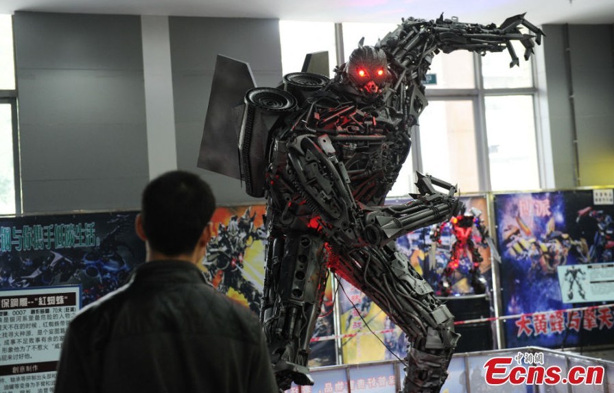 A robot statue is on display at an exhibition featured on characters of the American science fiction action film Transformers in Chengdu, Southwest China's Sichuan Province, March 19, 2013. The statues were made of parts from written-off vehicles. (CNS/Zhang Lang)