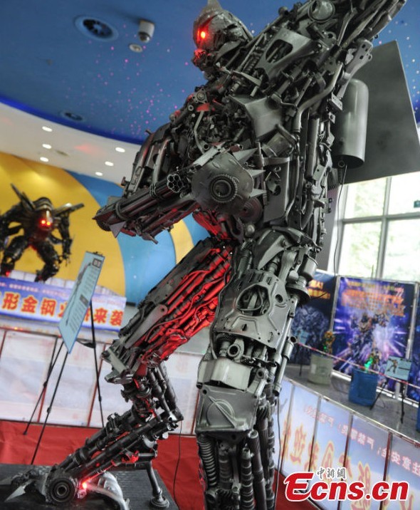 A robot statue is on display at an exhibition featured on characters of the American science fiction action film Transformers in Chengdu, Southwest China's Sichuan Province, March 19, 2013. The statues were made of parts from written-off vehicles. (CNS/Zhang Lang)