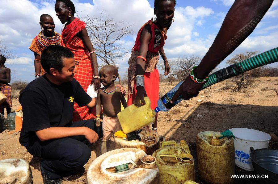 Local residents suffering from drought get water sent by China Wuyi (Kenya) Company, in Isiolo, north Kenya, July 21, 2011. The China-Africa strategic cooperation has created a promising win-win scenario for the world's largest developing country and the fast-emerging continent over past decades. Chinese President Xi Jinping will visit Tanzania, South Africa and the Republic of Congo later this month and attend the fifth BRICS summit on March 26-27 in Durban, South Africa. (Xinhua/Zhao Yingquan) 