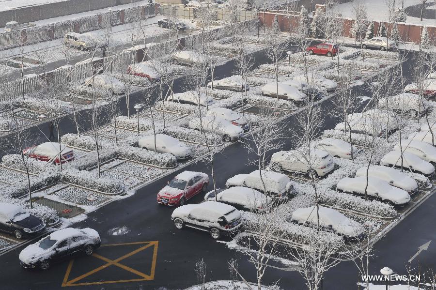 Cars are covered with snow at a parking lot in the Shijingshan District of Beijing, capital of China, March 20, 2013. Beijing witnessed a snowfall with a depth reaching 10-17 centimeters overnight. The snowfall happened to hit the city on the Chinese traditional calendar date of Chunfen, which heralds the beginning of the spring season. Chunfen, which literally means Spring Equinox or Vernal Equinox, falls on the day when the sun is exactly at the celestial latitude of zero degrees. (Xinhua/Lu Peng)