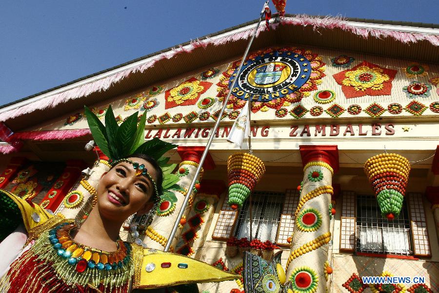 A dancer performs on a street during the Mango Festival in Zambales Province, the Philippines, March 20, 2013. The Mango Festival is held in Zambales annually to promote mango as the local signiture with colorful floats and street dances. (Xinhua/Rouelle Umali)