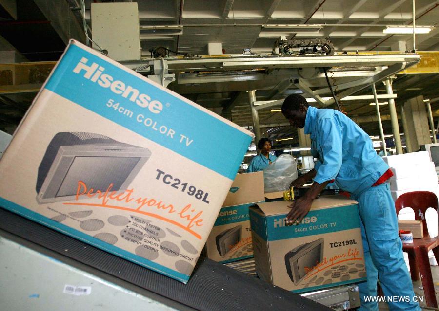 Workers pack televisions at a factory of Hisense Group, a Chinese electronic products manufacturer, in Johannesburg, South Africa, Sept. 21, 2006. China-Africa economic and trade cooperation is mutually beneficial, strongly boosting the common development of the two sides. Chinese President Xi Jinping will visit Tanzania, South Africa and the Republic of Congo later this month and attend the fifth BRICS summit on March 26-27 in Durban, South Africa. (Xinhua/Wang Ying)