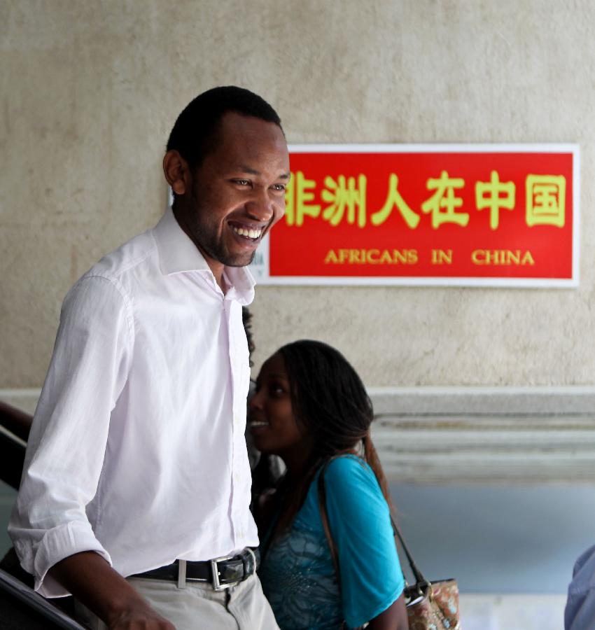 A student of Confucius Institute walks past a poster of China's Xinhua Gallery at Marien Ngouabi University in Brazzaville, the Republic of Congo, Feb. 27, 2013. In recent years, Africa has witnessed a growing passion for the Chinese language and increasing requests to set up Chinese teaching institutions. To cater to this growing need, China opened the Confucius Institute at the University of Nairobi in 2005, the first of its kind in Africa. The latest figure shows that there are 31 Confucius Institutes and 5 Confucius Classrooms in Africa as of September 2012. (Xinhua/Meng Chenguang)