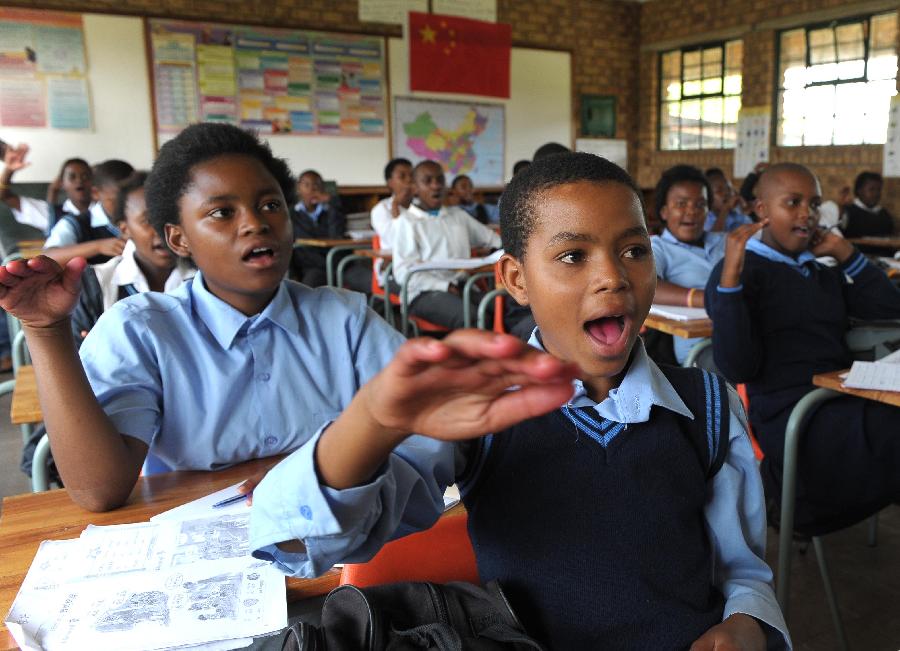 Students learn Chinese at a secondary school, 40 km east of Pretoria, South Africa, Feb. 25, 2013. In recent years, Africa has witnessed a growing passion for the Chinese language and increasing requests to set up Chinese teaching institutions. To cater to this growing need, China opened the Confucius Institute at the University of Nairobi in 2005, the first of its kind in Africa. The latest figure shows that there are 31 Confucius Institutes and 5 Confucius Classrooms in Africa as of September 2012. (Xinhua/Li Qihua)