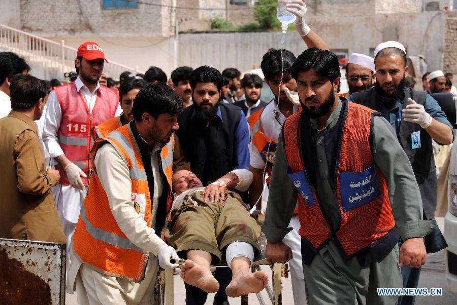 Rescuers transfer an injured man to a hospital in northwest Pakistan's Peshawar on March 21, 2013. At least 12 people were killed and 35 others injured when a bomb hit a refugee camp in Pakistan's northwest city of Nowshera on Thursday morning, local district officials said. (Xinhua/Ahmad Sidique)