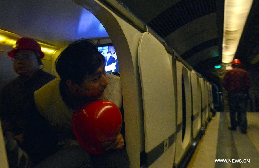 People take a train to watch a 4D movie at an underground cinema in the Kailuan national mine park in Tangshan, north China's Hebei Province, March 22, 2013. The 60-meter-deep cinema was reconstructed from a coal roadway which was built 130 years ago. The film showed in the cinema was about coal mining. (Xinhua/Zheng Yong)