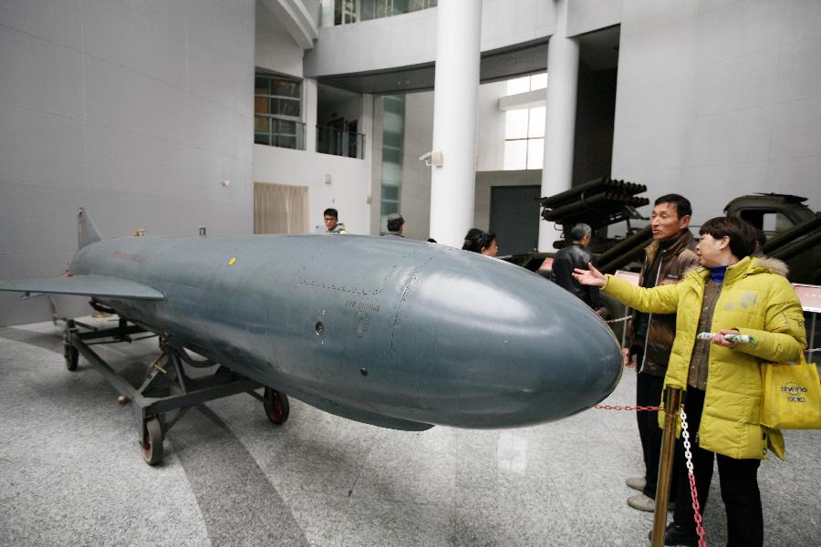 Tourists visit a missile at the weapon museum of Nanjing University of Science and Technology (NJUST) in Nanjing, capital of east China's Jiangsu Province, March 24, 2013. The NJUST opened to public to celebrate its 60th anniversary Sunday. The weapon museum collects about 6,000 weapons since the First World War. (Xinhua) 